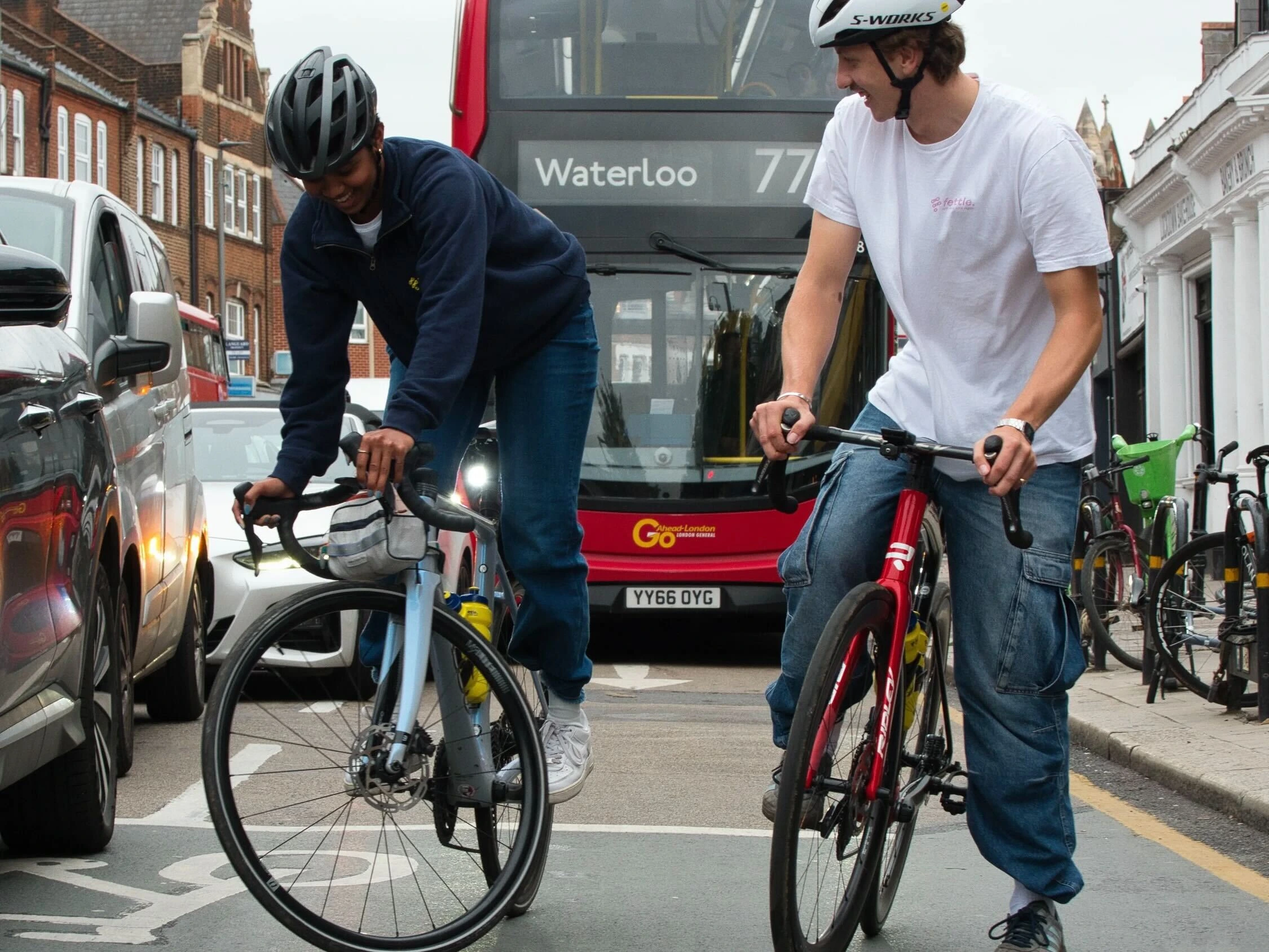 two cyclists in front of London TFL bus