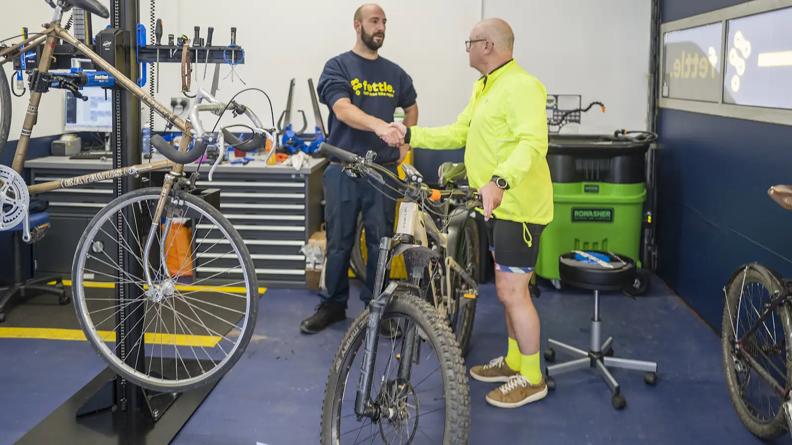Customer and service tech after a bike repair